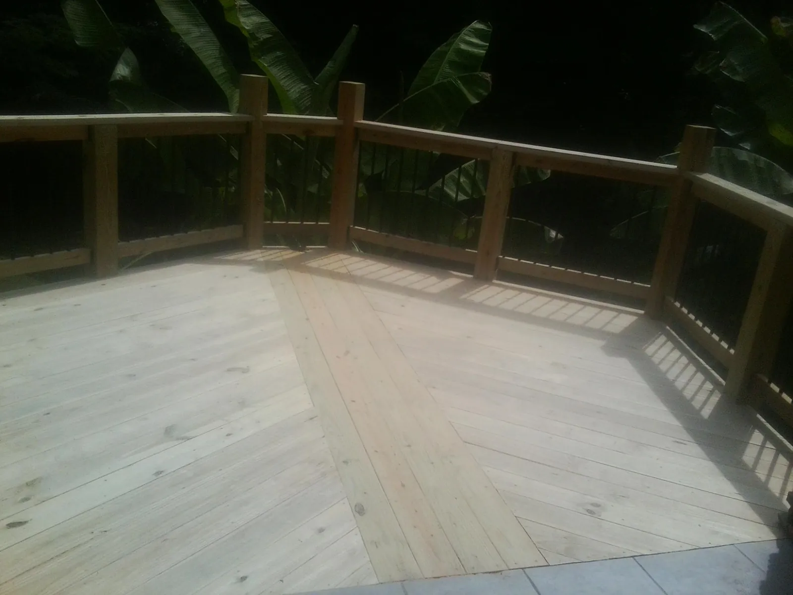 New wood deck and railing built off the back of a home in Jeremiah
