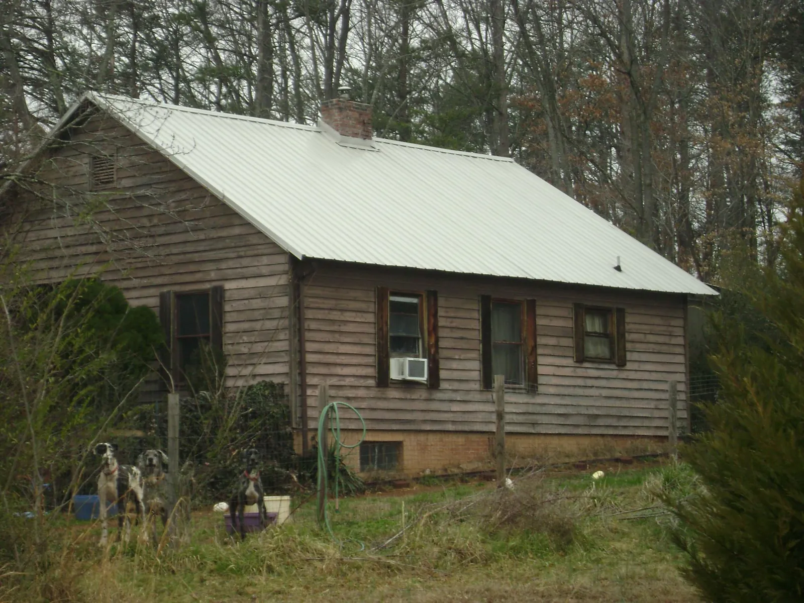 White metal roof on an old wood sided farmhouse, from a Metal Roof Installation job in Jeremiah
